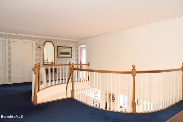 hall with carpet and ornamental molding