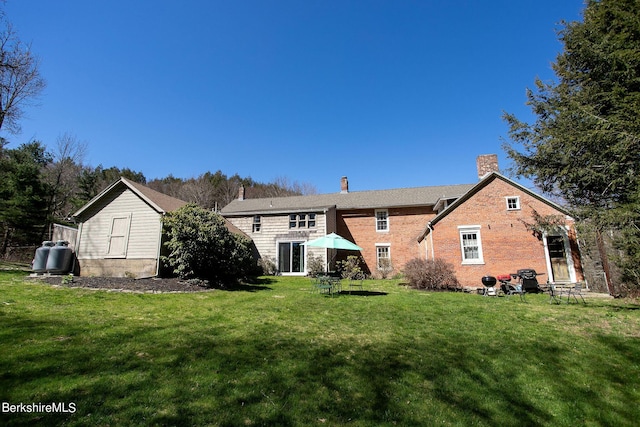 3 Lake Buel Rd, Great Barrington, MA 01230 - back of house featuring a lawn, brick siding, and a chimney