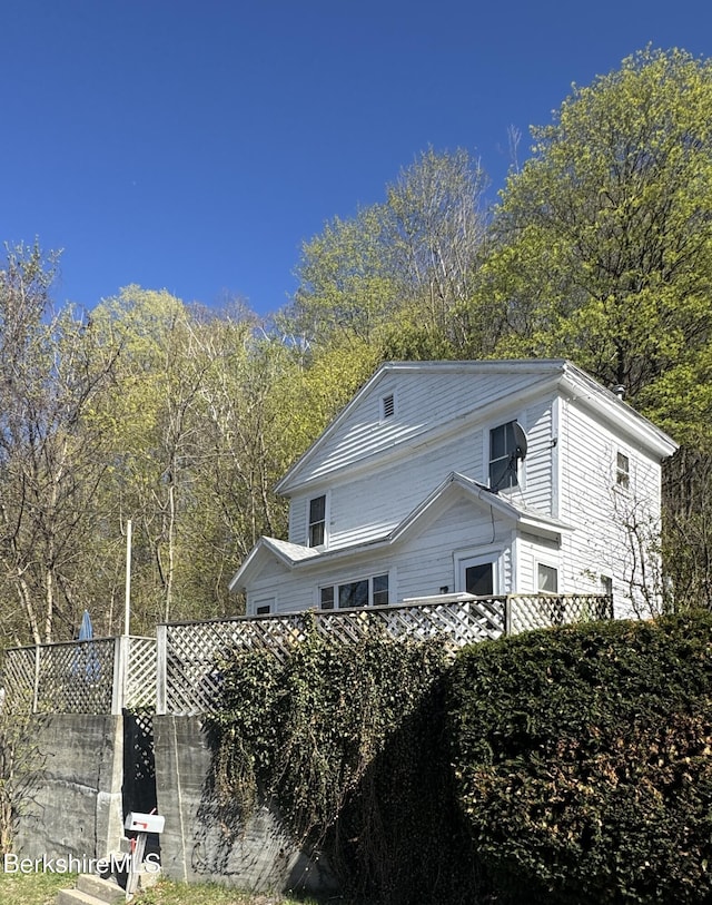 view of home's exterior featuring fence