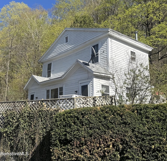 view of side of property featuring a deck