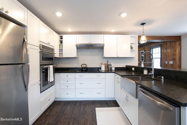 kitchen featuring white cabinetry, appliances with stainless steel finishes, and decorative light fixtures