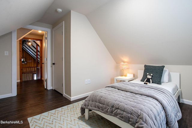 bedroom featuring lofted ceiling and dark hardwood / wood-style floors