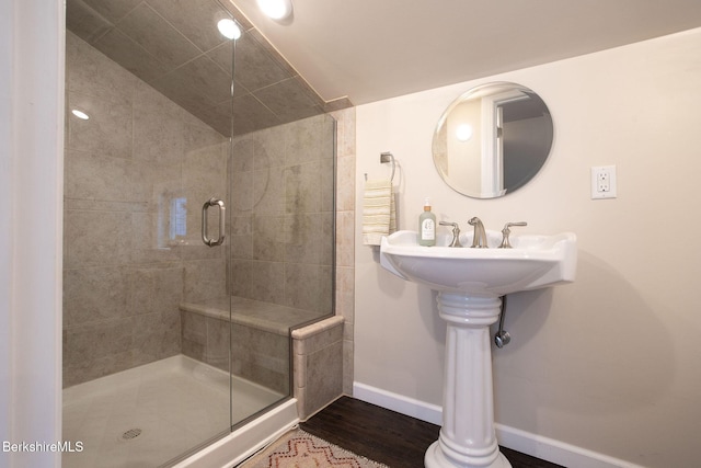 bathroom with hardwood / wood-style flooring and an enclosed shower