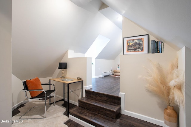 home office featuring baseboards, vaulted ceiling, and wood finished floors