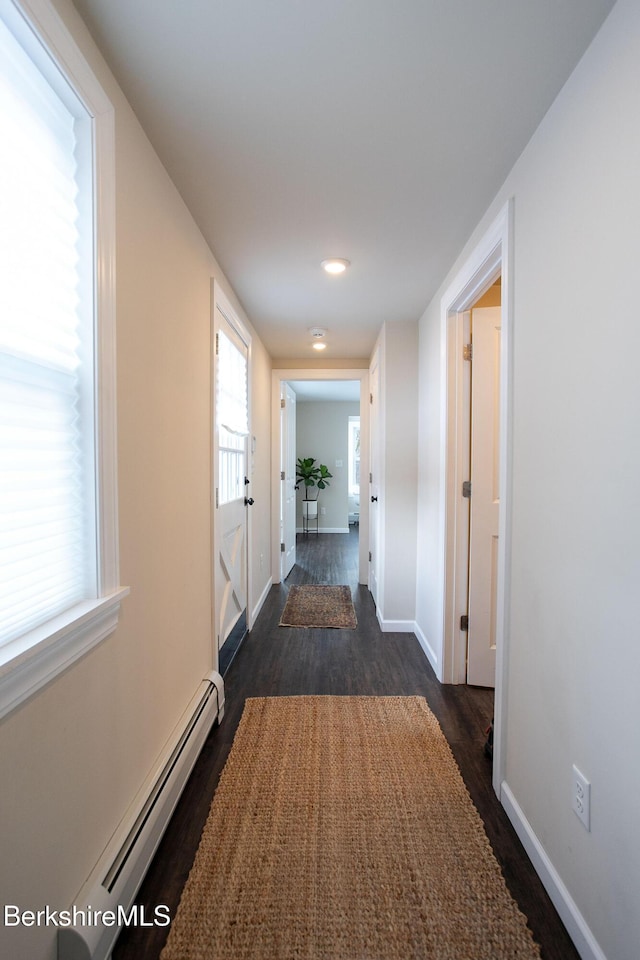 hallway featuring dark hardwood / wood-style flooring and baseboard heating