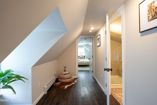 hallway with dark hardwood / wood-style flooring, a baseboard heating unit, and vaulted ceiling