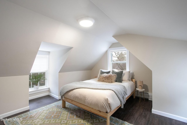 bedroom with baseboards, a baseboard heating unit, wood finished floors, and lofted ceiling