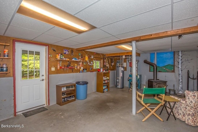 49 Bryant Rd, Otis, MA 01253 - basement featuring a wood stove, a paneled ceiling, and gas water heater