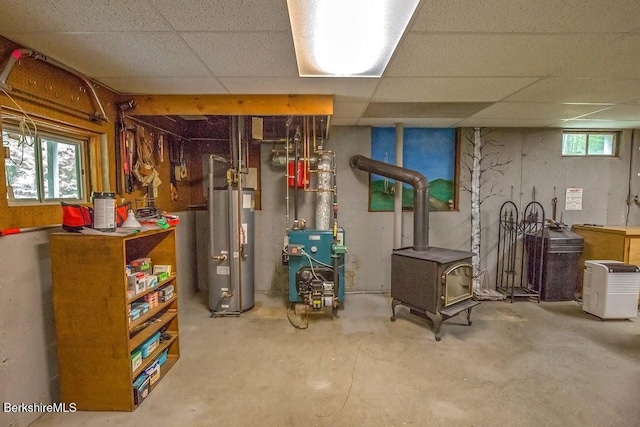 49 Bryant Rd, Otis, MA 01253 - below grade area featuring gas water heater, a wood stove, a heating unit, and a drop ceiling