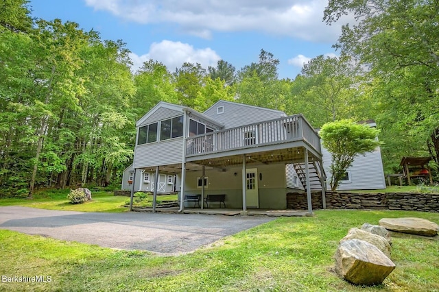 49 Bryant Rd, Otis, MA 01253 - rear view of property featuring a sunroom, a deck, driveway, a yard, and a patio area