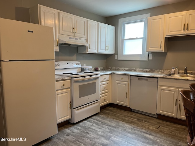 94 John St, Pittsfield, MA 01201 - kitchen with white appliances, under cabinet range hood, white cabinetry, dark wood-style flooring, and light countertops