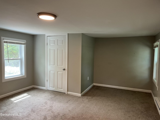 94 John St, Pittsfield, MA 01201 - unfurnished bedroom featuring carpet and a baseboard heating unit