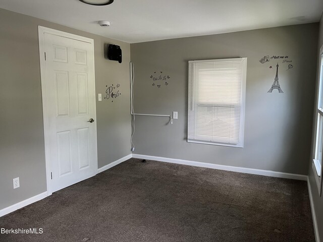 94 John St, Pittsfield, MA 01201 - unfurnished room with dark colored carpet and a smoke detector