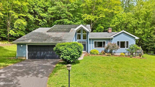 505 Kirchner Rd, Dalton, MA 01226 - view of front facade featuring driveway, a chimney, roof mounted solar panels, and a front yard
