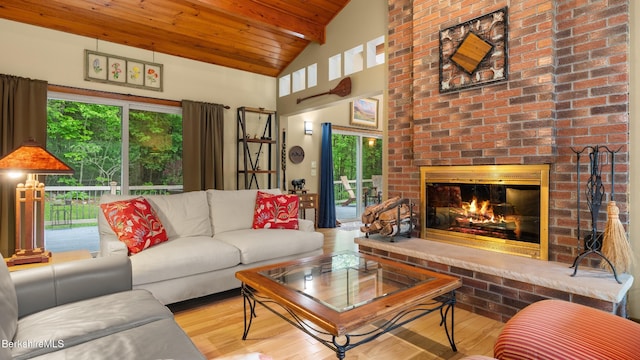 505 Kirchner Rd, Dalton, MA 01226 - living area with wooden ceiling with exposed beams, plenty of natural light, wood finished floors, a brick fireplace, and high vaulted ceiling