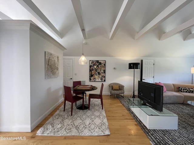 dining room featuring lofted ceiling with beams and wood-type flooring