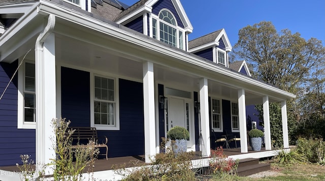 view of property exterior featuring covered porch