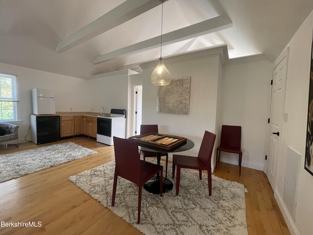 dining area featuring beam ceiling and light wood-type flooring