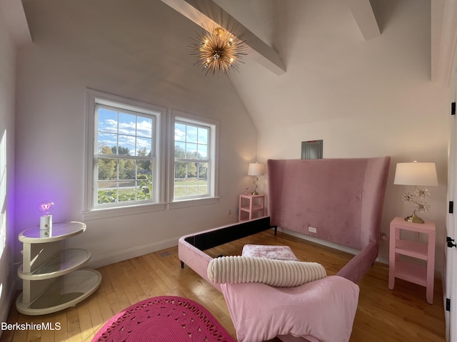 bedroom featuring light wood-type flooring, vaulted ceiling with beams, and an inviting chandelier