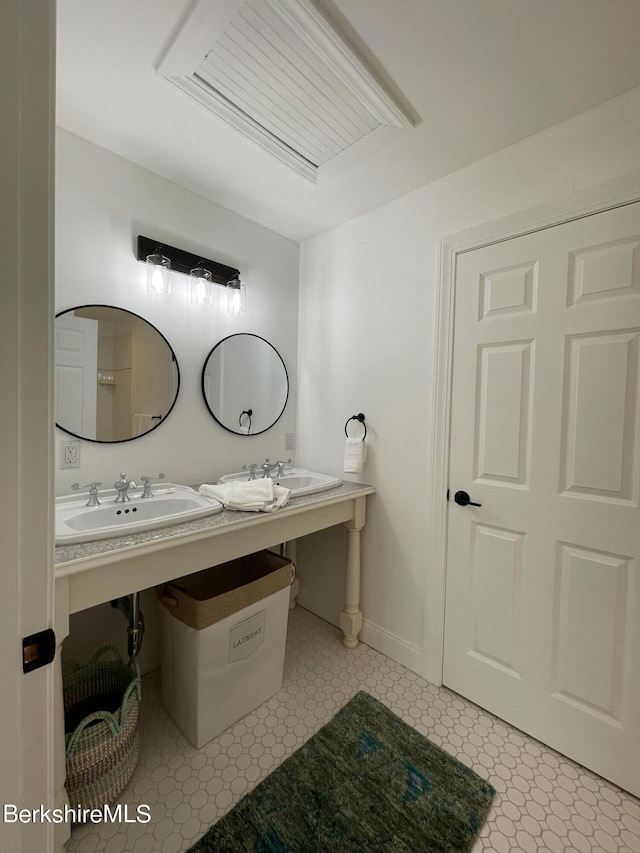 bathroom with dual sinks