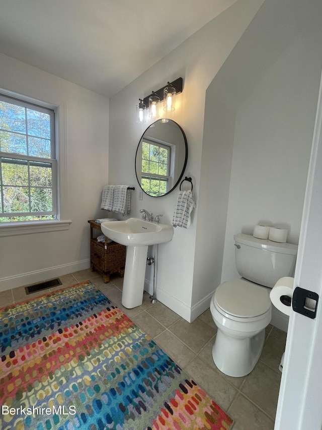 bathroom with tile patterned flooring, toilet, and sink