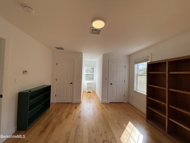 interior space with plenty of natural light and light hardwood / wood-style floors