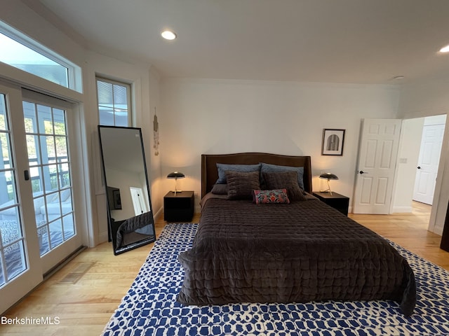 bedroom featuring access to exterior and light wood-type flooring