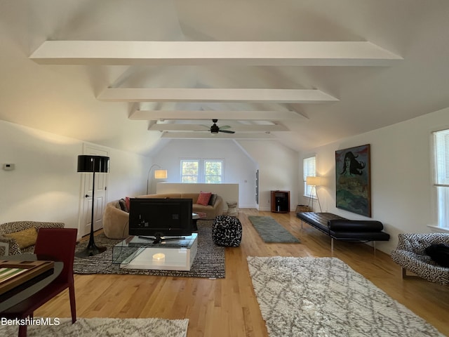 living room featuring vaulted ceiling with beams, ceiling fan, and wood-type flooring