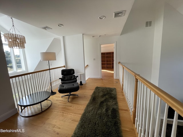 living area featuring a chandelier and light hardwood / wood-style floors