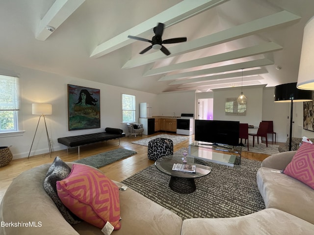 living room with vaulted ceiling with beams, light hardwood / wood-style flooring, and ceiling fan