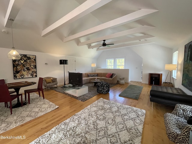 living room with vaulted ceiling with beams, ceiling fan, and hardwood / wood-style floors