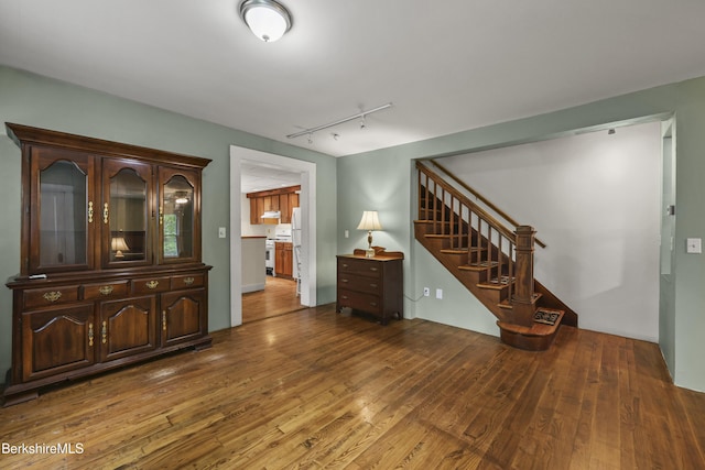 9 High St, Lenox, MA 01240 - living room with wood-type flooring, stairs, and rail lighting