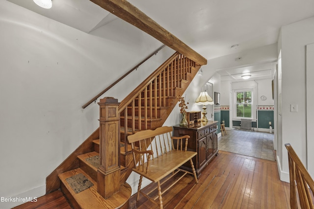 9 High St, Lenox, MA 01240 - staircase with baseboards, hardwood / wood-style floors, and radiator heating unit