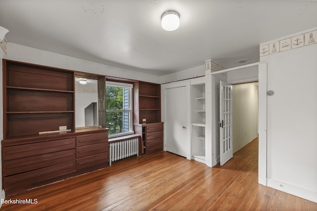 9 High St, Lenox, MA 01240 - unfurnished bedroom with radiator, hardwood / wood-style floors, and a closet
