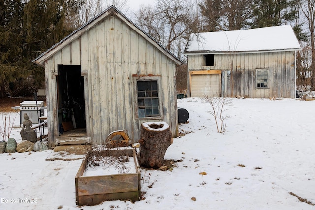 snow covered structure with a garage