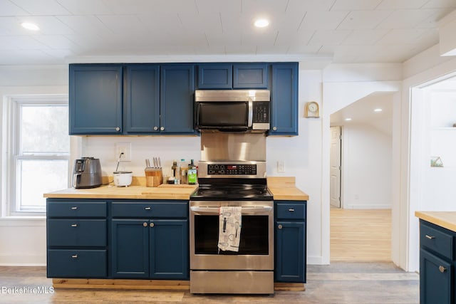 kitchen with blue cabinetry and appliances with stainless steel finishes