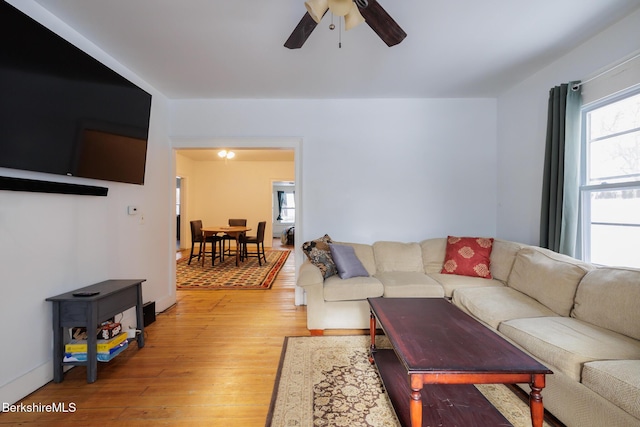 living room featuring light wood-type flooring and ceiling fan