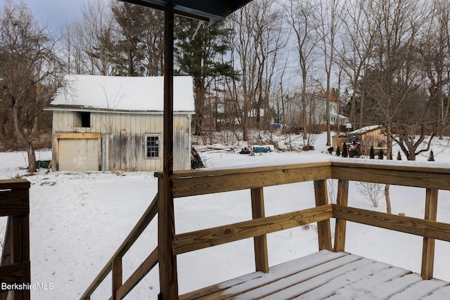 snow covered deck featuring a garage