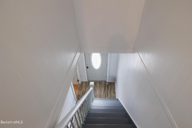 stairway with hardwood / wood-style flooring