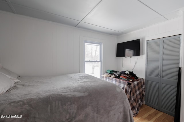 bedroom with hardwood / wood-style floors and a closet