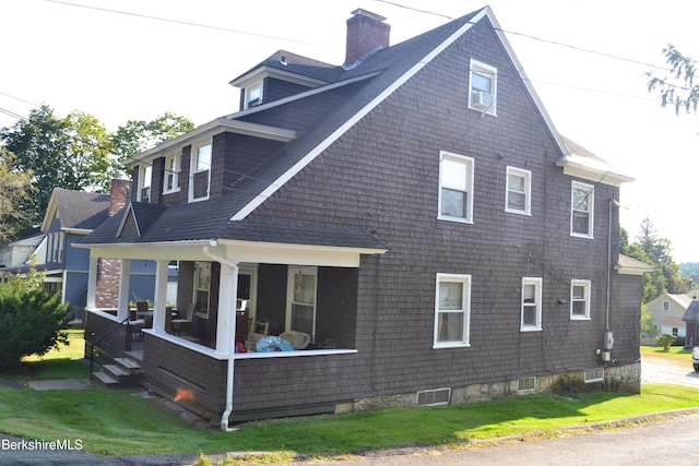 view of home's exterior featuring a lawn and covered porch