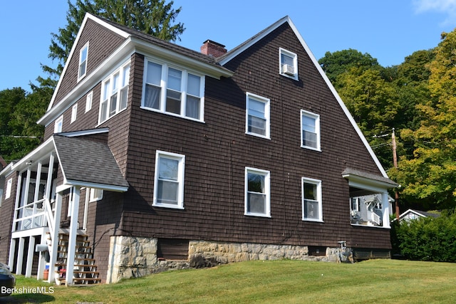 view of side of property with a yard