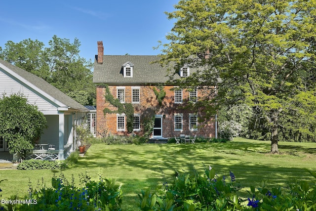 rear view of house with a yard