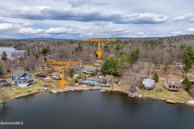 aerial view with a water view and a forest view
