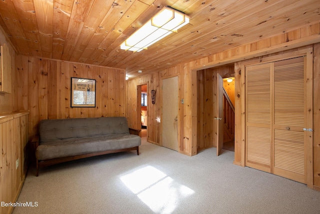 unfurnished room with wood walls, wood ceiling, and carpet flooring