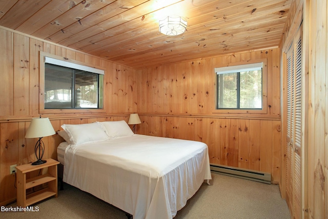 bedroom featuring a baseboard radiator, wood walls, wood ceiling, and light colored carpet