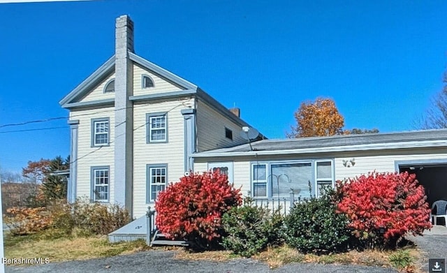 view of side of property featuring a chimney
