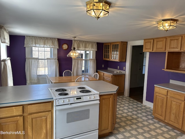 kitchen with electric stove, light flooring, glass insert cabinets, and decorative light fixtures