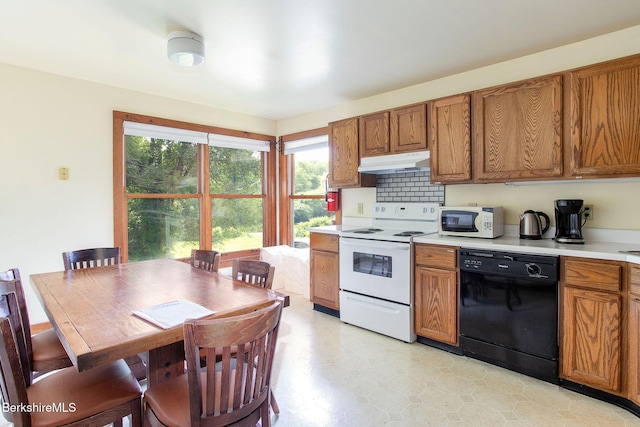 2049 S Undermountain Rd, Sheffield, MA 01257 - kitchen with white appliances, under cabinet range hood, brown cabinets, light countertops, and light floors