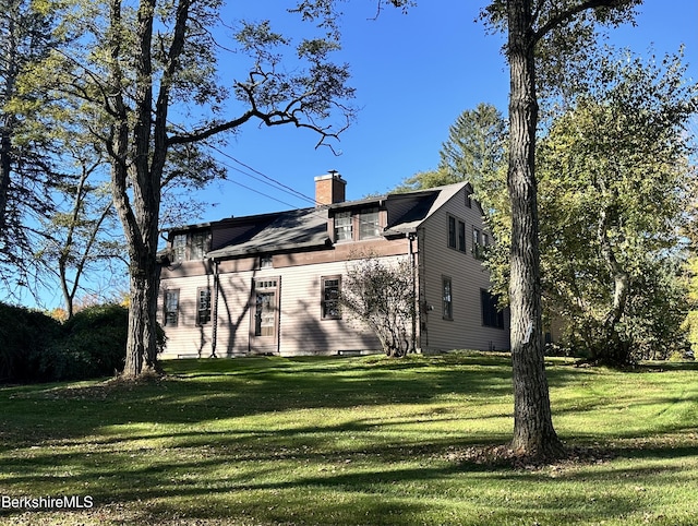 rear view of house with a yard